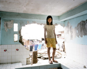 Girl in a broken kitchen